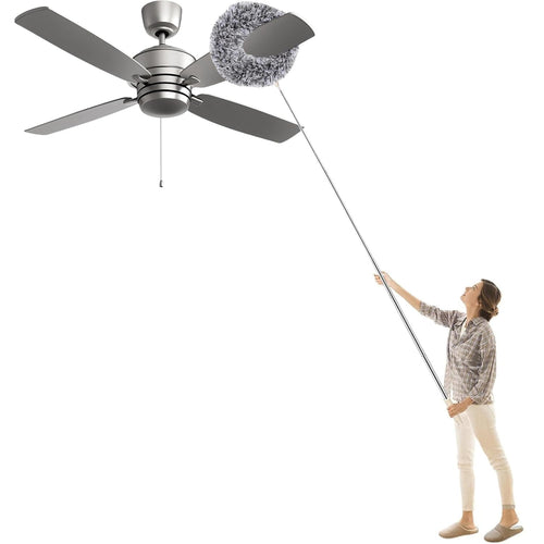 Woman cleaning a ceiling fan from the floor with the round microfiber duster on a 10 ft extendable steel pole